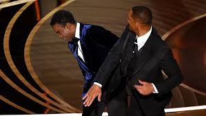 Will Smith hits Chris Rock across the faces at the 2022 Oscars after Rock made a joke about Jada, Wills wife.