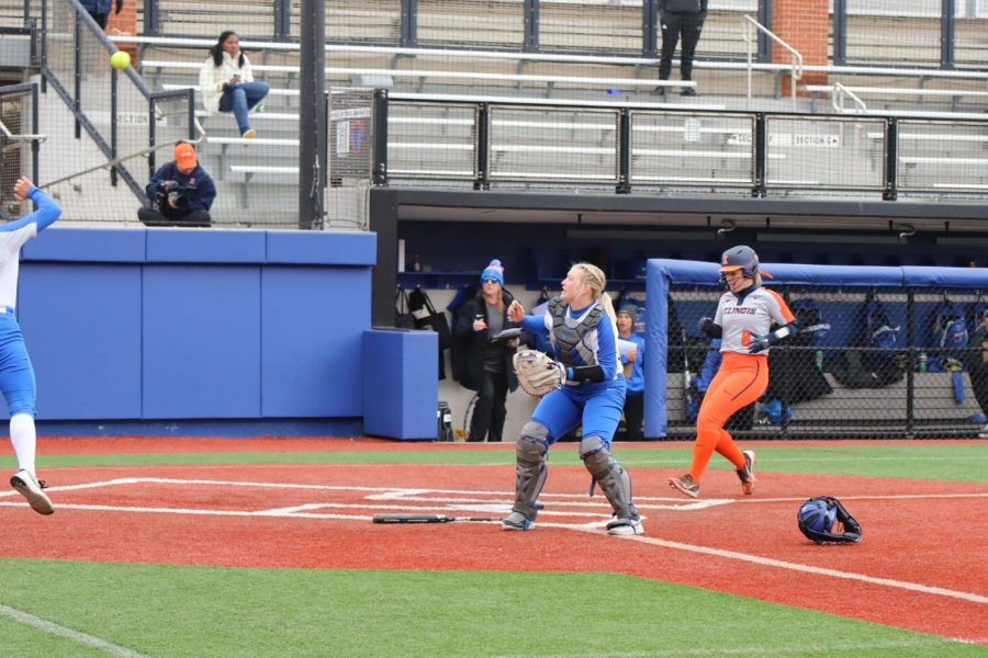 DePaul catcher Riley Pool watches the ball in the air as an Illinois player scores in the Blue Demons' 6-1 loss on Wednesday. 