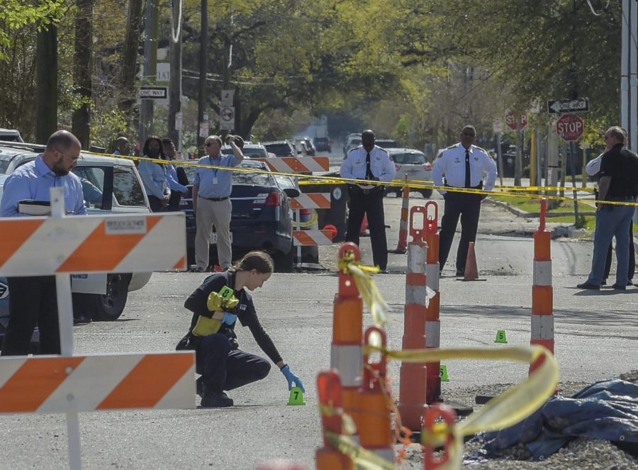 Members of the New Orleans Police Department investigate a carjacking scene on N. Pierce St. that resulted in an elderly woman's death in New Orleans, La., Monday, March 21, 2022. (Max Becherer/The Times-Picayune/The New Orleans Advocate via AP)