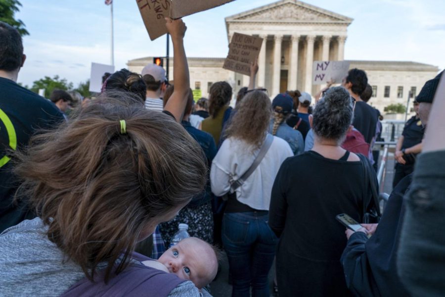 Katie+McDevitt+of+Washington%2C+nurses+her+6-week-old+baby+Declan%2C+as+they+join+demonstrators+protesting+outside+of+the+U.S.+Supreme+Court%2C+Tuesday%2C+May+3%2C+2022%2C+in+Washington.+A+draft+opinion+suggests+the+U.S.+Supreme+Court+could+be+poised+to+overturn+the+landmark+1973+Roe+v.+Wade+case+that+legalized+abortion+nationwide%2C+according+to+a+Politico+report+released+Monday.+%28AP+Photo%2FJacquelyn+Martin%29