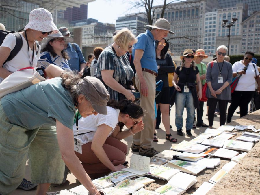 The urban sketchers gather to admire each other's work at the end of their meeting in their 