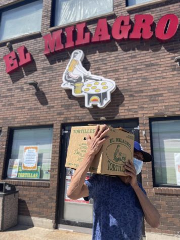 A client buys a box of tortillas from El Milagro in Little Village.