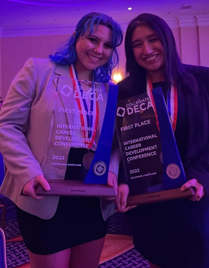 Sophomores+Sofia+Feijoo+and+Alex+Martinez+hold+their+glass+plaques+at+ICDC.+The+pair+won+first+place+in+Event+Planning