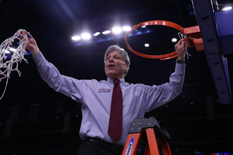 DePaul women's basketball head coach Doug Bruno holds the net in the air after the Blue Demons' 74-73 win over Marquette at the Big East Tournament at Wintrust Arena on March 12, 2019.