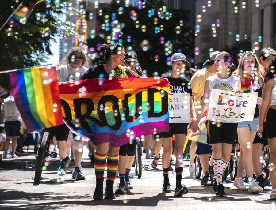 People walk in the Pittsburgh Pride Revolution March to celebrate Pride Month, Saturday, June 4, 2022, in downtown Pittsburgh.