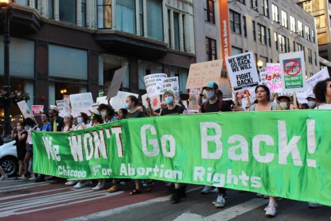 Abortion rights organizers march down the streets holding a green We WONT Go Back! making their stance against the end of nearly 50 years of abortion rights. 