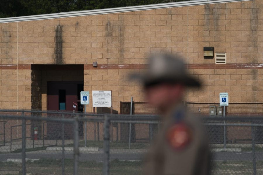 FILE - A back door at Robb Elementary School, where a gunman entered through to get into a classroom in last weeks shooting, is seen in the distance in Uvalde, Texas, Monday, May 30, 2022. (AP Photo/Jae C. Hong, File)
