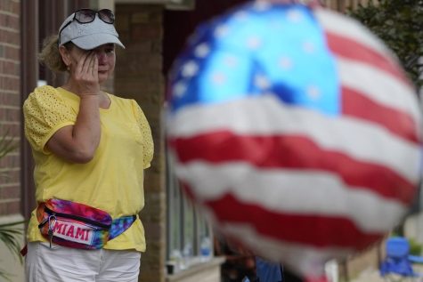 A woman wipes tears after a mass shooting at the Highland Park Fourth of July parade in Highland Park, Ill., a Chicago suburb, Monday, July 4, 2022. (AP Photo/Nam Y. Huh)
