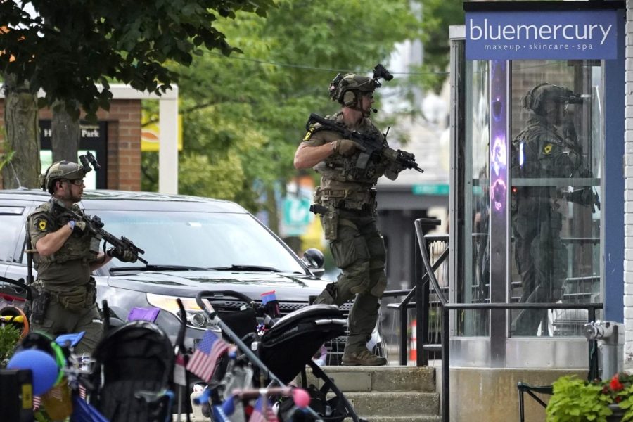 Law enforcement conduct a search after a mass shooting at the Highland Park Fourth of July parade in downtown Highland Park, Ill., a Chicago suburb on Monday, July 4, 2022. 