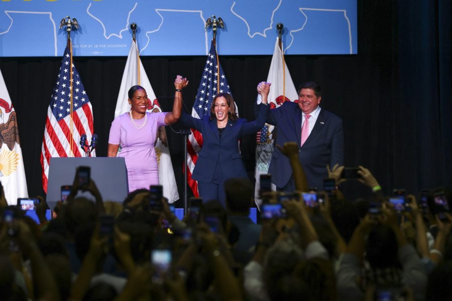 Vice President Kamala Harris (center) along with Lt. Gov. Juliana Stratton (left) and Gov. J.B. Pritzker (right) raise hands in support of one another during the rally.
