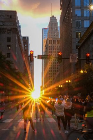 For two weeks every year around the spring and fall equinox, the sunset and sunrise line up perfectly with the east-west streets in the city. Taken on Randolph and Dearborn.