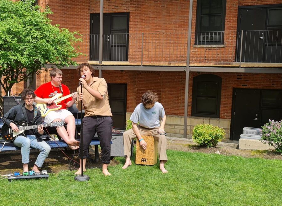 The band Socks Off preforms for a student audience on the Sanctuary Hall courtyard.