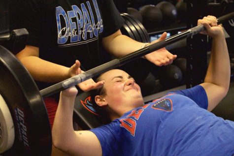 Noelle Malkamaki bench presses during a track and field strength training practice. Malkamaki has begun training for the Paris 2024 Paralympics, while also competing for DePaul.