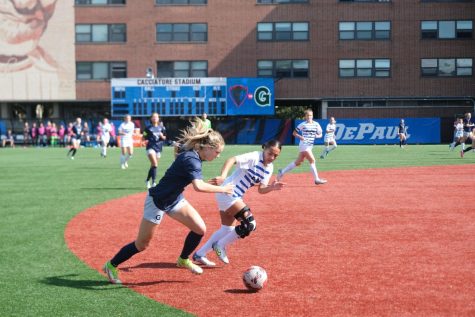 Junior defender Bella Hanisch fights for the ball against Georgetown during Sunday’s 1-0 loss.