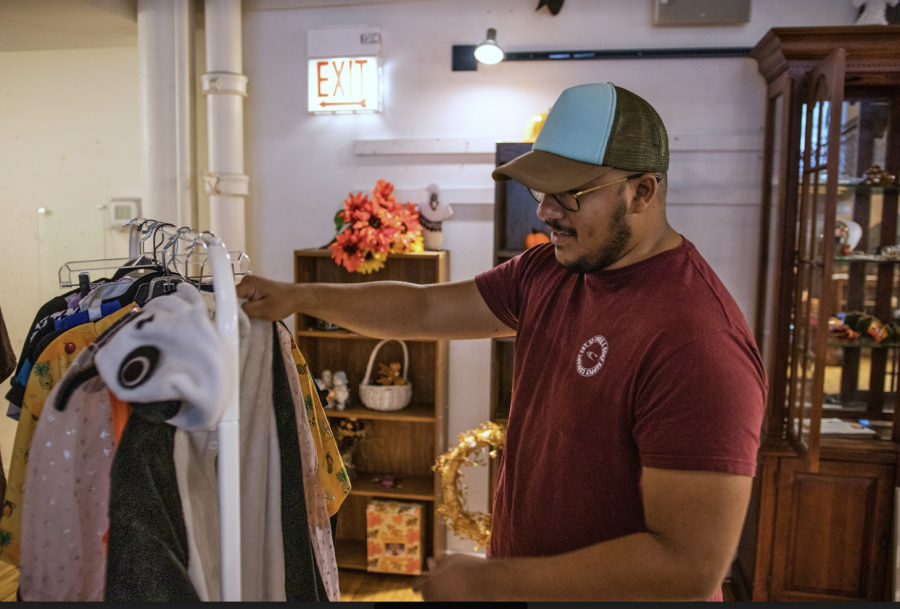 A customer browses the secondhand selection at the Brown Elephant thrift store.
