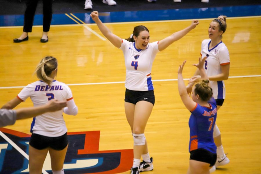 Defensive specialist Julia Nagy (4) celebrates with teammates after the Blue Demons score a point during Friday’s 3-0 loss to St. John’s.