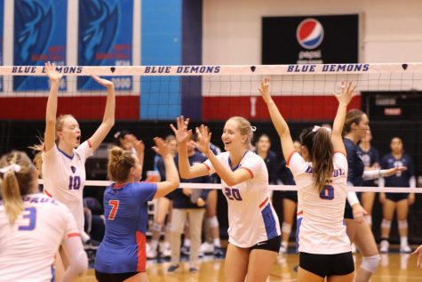 Junior middle blocker Sara Griffith (20) celebrates with teammates in DePauls win over Villanova on Friday.