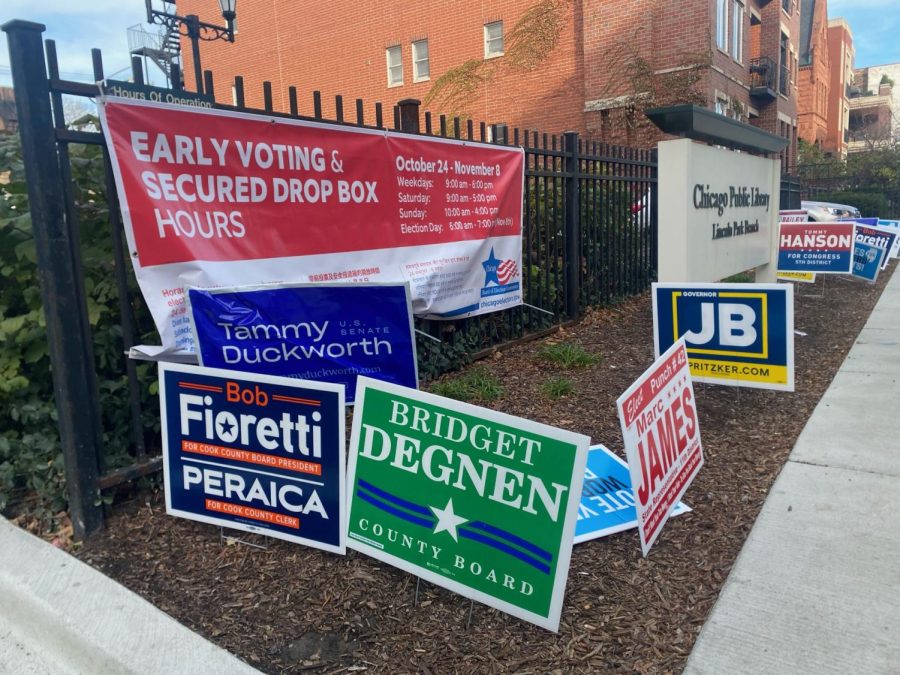 Signs line the curb outside a polling location at the Chicago Public Library Lincoln Park branch on Election Day.