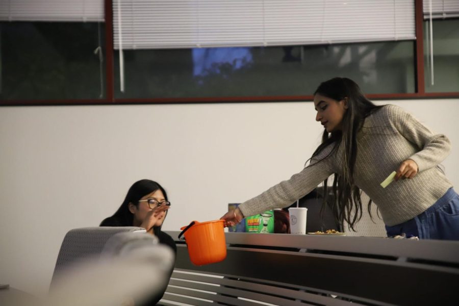 Parveen Mundi [right], Student Government Association (SGA) EVP of Student Affairs, participates in a group activity at the SGA meeting.