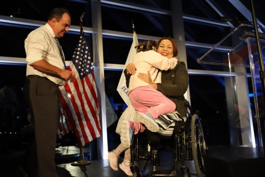 Sen. Tammy Duckworth hugs her daughters on stage as her husband Bryan Bowlsbey looks on at Duckworths victory party at Adler Planetarium in Chicago Tuesday night.