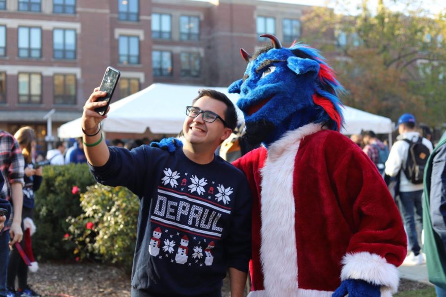 Student Government president Kevin Holechko snaps a selfie with DePaul mascot, Dibs.