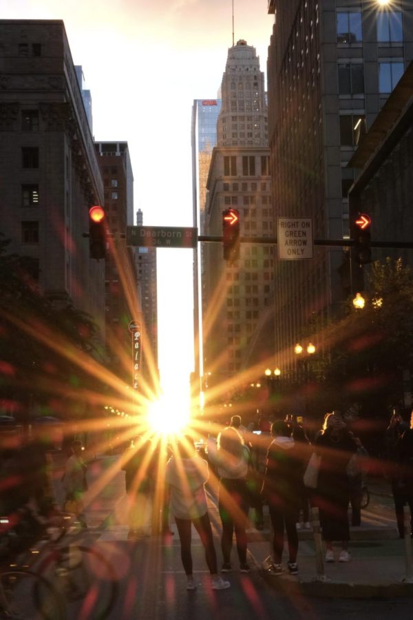 Onlookers capture the beauty of the Chicagohenge sunset on Dearborn street.
