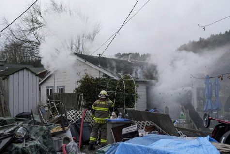 Firefighters battle a residence fire in Rio Dell, Calif., Wednesday, Dec. 21, 2022.