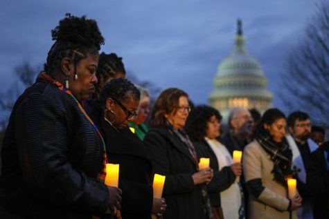 The Rev. Dr. Cassandra Gould, left, gathers with other Christian leaders for a prayer vigil to mark the second year anniversary of the insurrection on Capitol Hill in Washington D.C.