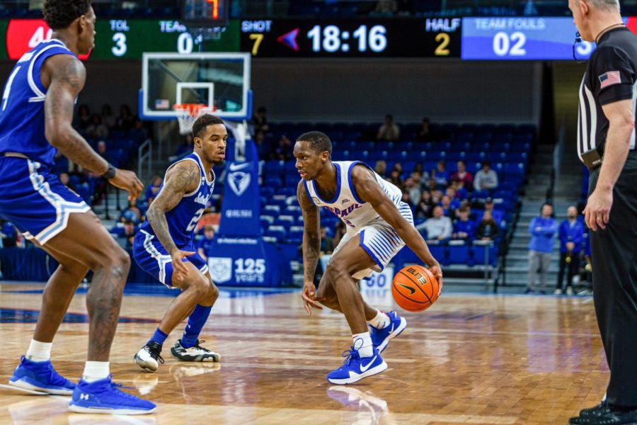 Graduate guard Umoja Gibson dribbles towards two Seton Hall defenders during Saturday’s 71-67 loss. The Blue Demons fell to 8-10 on the season and 2-5 in Big East conference play.