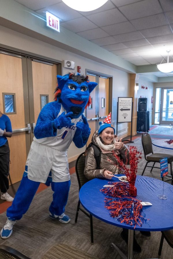 DIBS poses with DePaul student Gulbanu Madiyarova at his birthday event in the Lincoln Park Student Center. Snacks, and complimentary caricature were avaible for attendees.