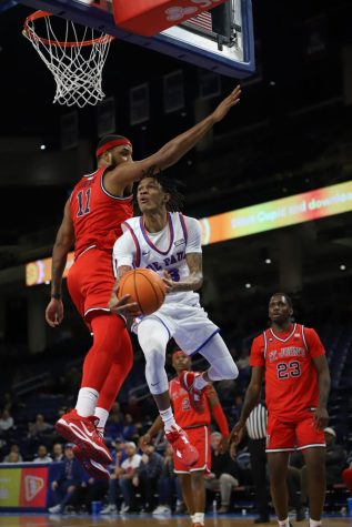 Senior guard Jalen Terry puts up a reverse layup against St. John’s senior center Joel Soriano during Tuesday’s 92-83 loss to the Storm at Wintrust Arena.