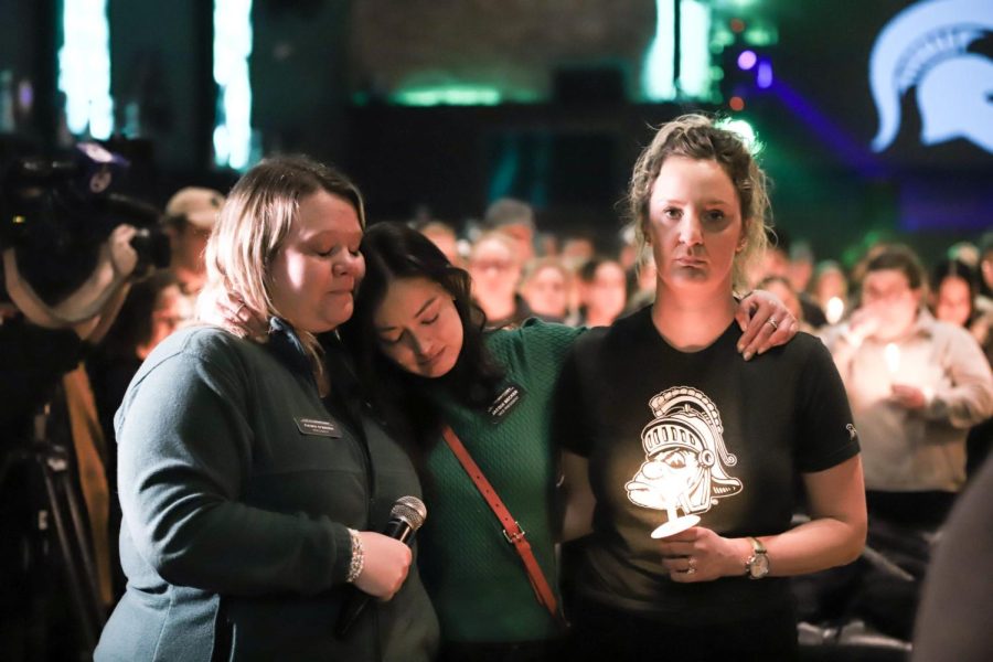 (From left) Fawn O’Brien, Jacqui Becker and Jessica Paski joined other Chicago Spartans at a candlelight vigil at Tree House Bar Saturday, Feb. 18. in the wake of the Feb. 13 shooting in East Lansing, Mich.