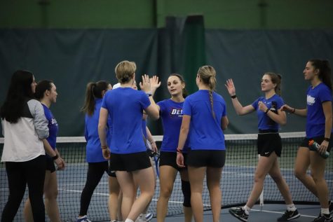 Graduate student Lenka Antonijevic celebrates with her teammates after securing her singles victory against Kansas State during Friday nights, 4-0 win.