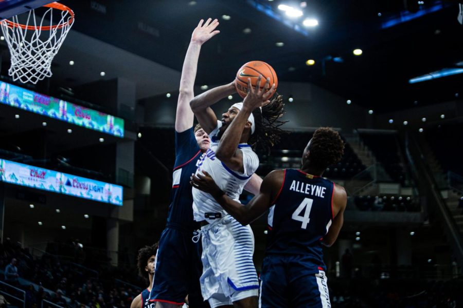 Junior forward DaSean Nelson attempts a shot between UConn defenders in DePauls loss to the Huskies Tuesday Night.