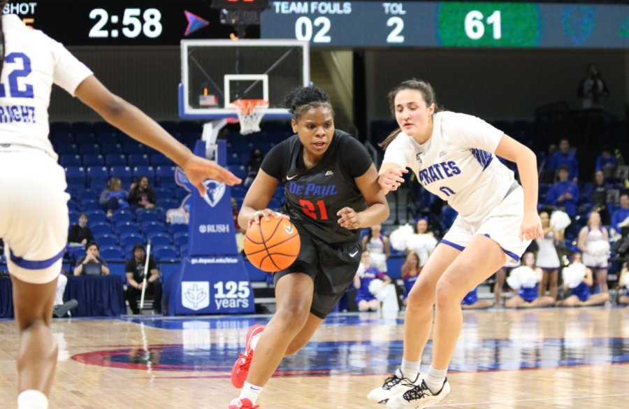 Junior guard Darrione Rogers drives past Pirates forward Alex Allesch for the contested layup during Wednesday’s 94-89 win against Seton Hall.