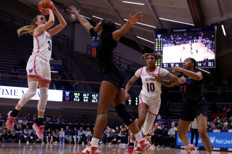 Sophomore guard Lucy Olsen puts up a jumper over DePaul sophomore forward Aneesah Morrow at Finneran Pavilion Tuesday Night.
