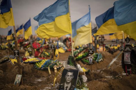 A photograph of a Ukrainian serviceman adorns a grave in the Alley of Glory portion of the cemetery, in Kharkiv, Ukraine.