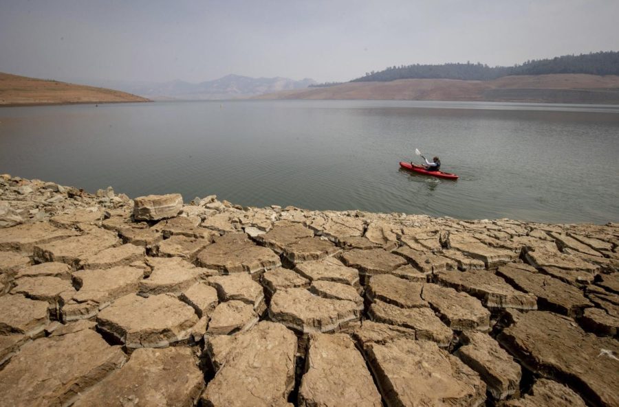 A kayaker fishes in Lake Oroville as water levels remain low due to continuing drought conditions in Oroville, Calif. in 2021. Now, the lake levels are above their historical average.