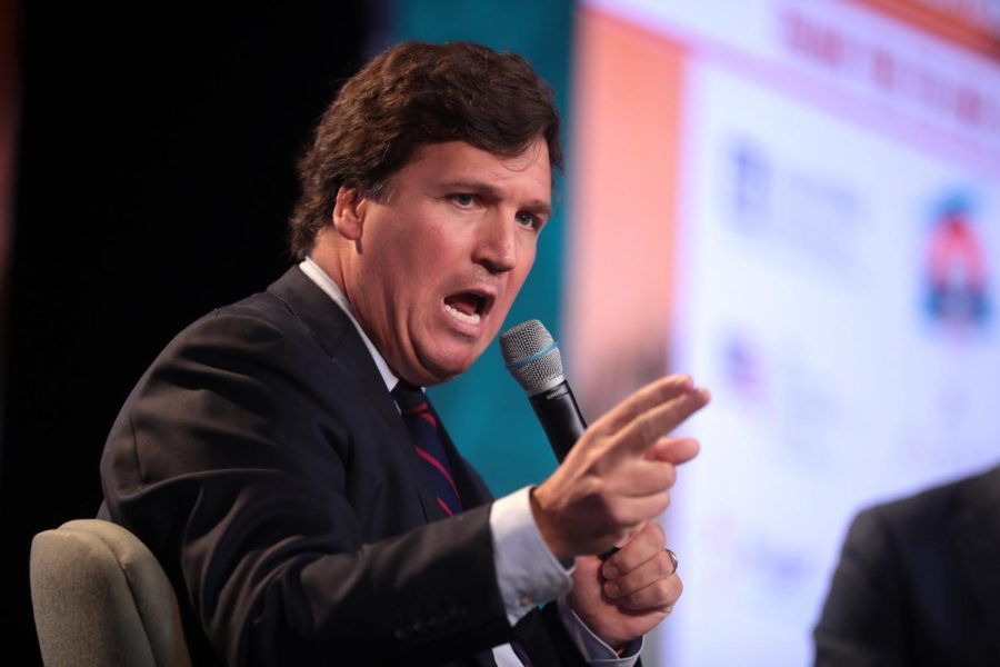 Political commentator Tucker Carlson speaks with attendees at the 2018 Student Action Summit. Carlson recently severed ties with Fox News.
