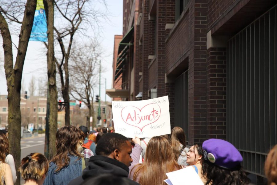 Students gather along Sheffield Ave between Fullerton and Belden Ave on April 10 to show support for faculty and staff at risk of losing their jobs in wake of DePaul’s budget gap.