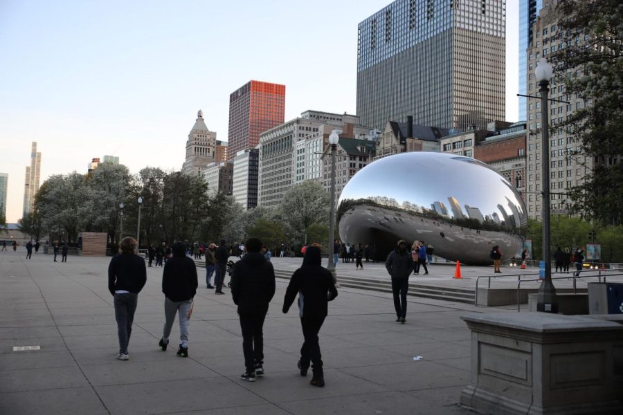 Visitors+walk+by+The+Bean+on+April+26+in+Millennium+Park.+Chicago+Mayor+Lori+Lightfoot+has+reinforced+the+parks+curfew+for+minors+after+large+youth+gatherings+resulted+in+recent+violence.