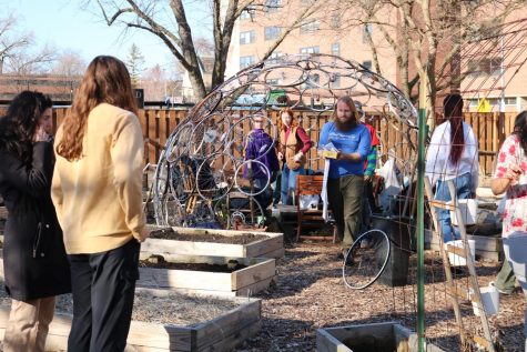 A DePaul Urban Gardeners Board Member leads a group discussion in the bicycle dome.
