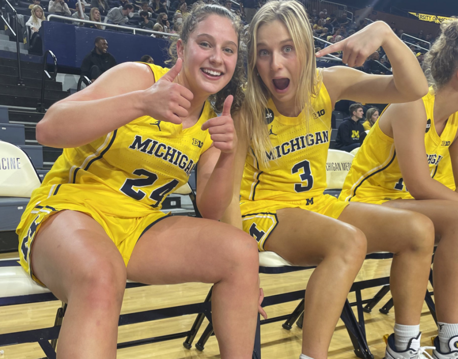 Michelle Sidor (left) and former teammate Maddie Nolan pose together on the floor of Crisler Arena in 2022.