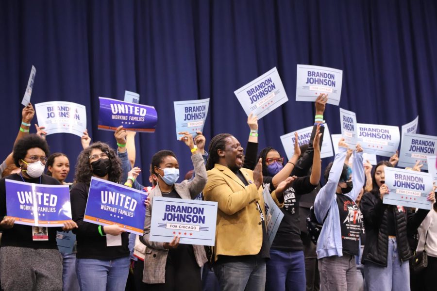 Organizers and volunteers for Brandon Johnsons campaign cheer as Johnson and U.S. Senator Bernie Sander takes the stage at rally at UIC CreditUnion1 Arena ahead of runoff election on April 4.