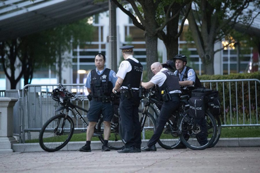 A group of Chicago Police Department officers circle together at Millennium Park during the period of the park's heightened security last May. 