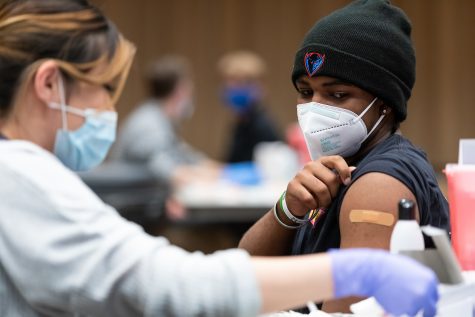 A DePaul student receives a COVID-19 vaccine, Wednesday, April 28, 2021, in the Lincoln Park Student Center. The Moderna vaccine clinic was open to DePaul students, faculty and staff April 27-30, 2021 and was conducted in partnership with Michigan Avenue Immediate Care. (DePaul University/Jeff Carrion)