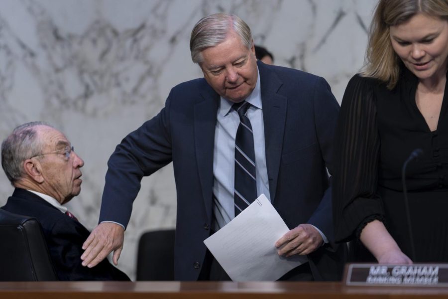 (Left) Sen. Chuck Grassley is greeted by Sen. Lindsey Graham as the panel holds a hearing at the Capitol about criticisms of the ethical practices of some Supreme Court justices in Washington on May 2.