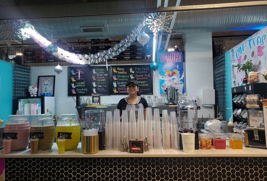 Cynthia Peralta, the owner of Cin-Tin Boba, stands behind her counter withan array of drinks.
