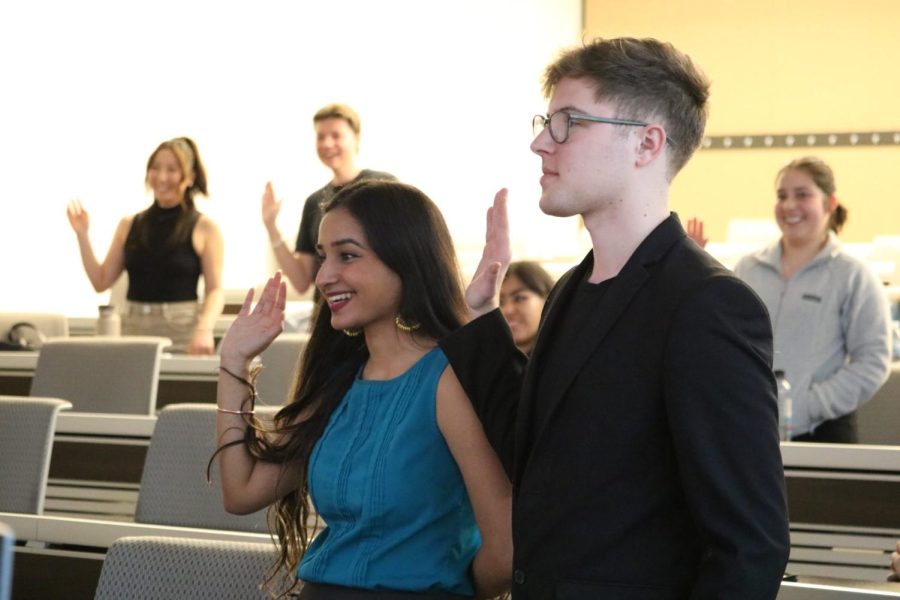 (Left) Parveen Mundi, SGA 2023-24 president, and Avery Schoenhals, SGA 2023-24 vice president, are sworn into their positions on May 11.