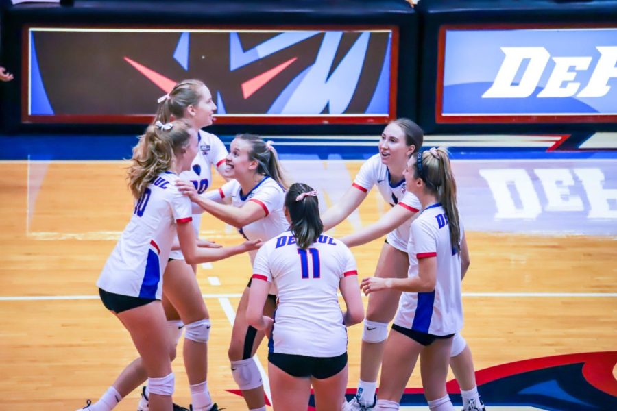 The Demons celebrate a set win at McGrath-Philips during DePaul’s Invitational Tournament.